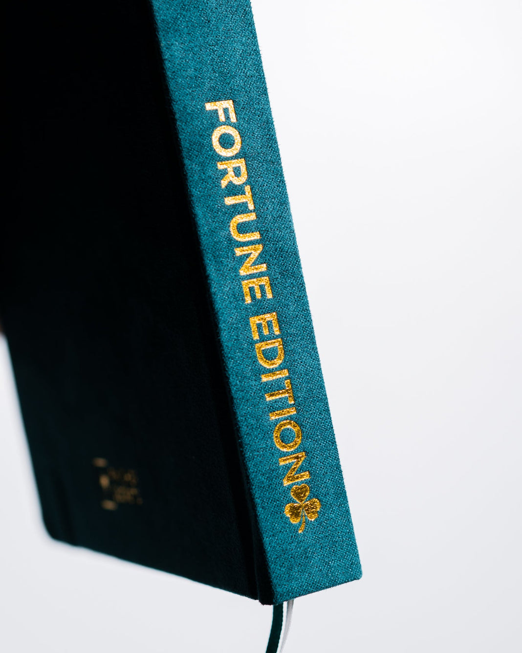Book with a teal spine labeled 'Fortune Edition' on a white background